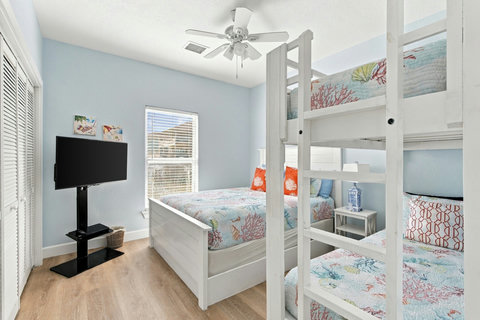 Full bed and bunk with a TV
