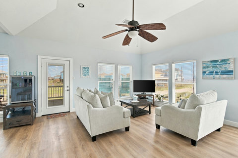 Bright living room with comfy sofas and a TV
