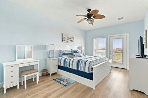 Upstairs primary suite with a king bed and deck access