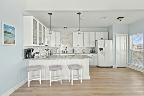 White kitchen with a breakfast bar for three