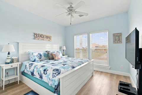 Downstairs bedroom with a king bed and TV