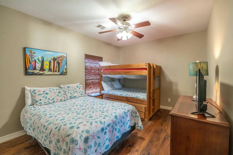 Bedroom with a queen bed and a queen-over-queen bunk