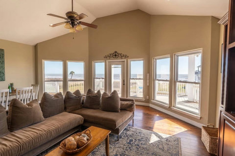 Living room with wall-to-wall windows facing the water