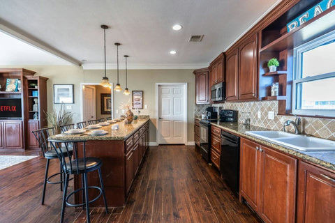 Full kitchen with a long granite counter