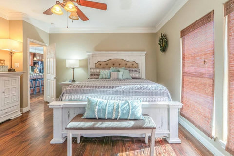 King bedroom with a carved headboard and bench