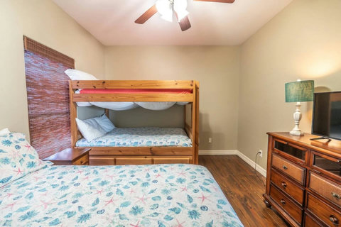 Queen bed and bunk with a TV