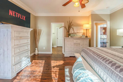 King bedroom with a smart TV and dressers
