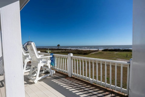 Tall deck chairs facing the beach