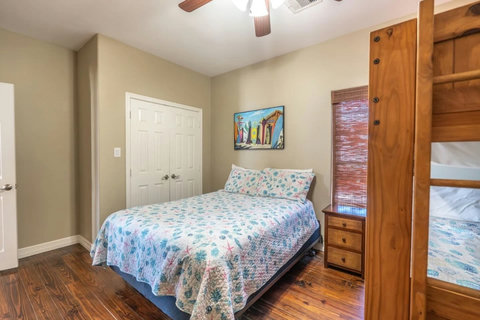 Queen bed in bunk room with a closet