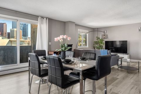 The dining area serves as a central gathering space, furnished with a robust table and comfortable seating, perfect for intimate meals or larger social events.