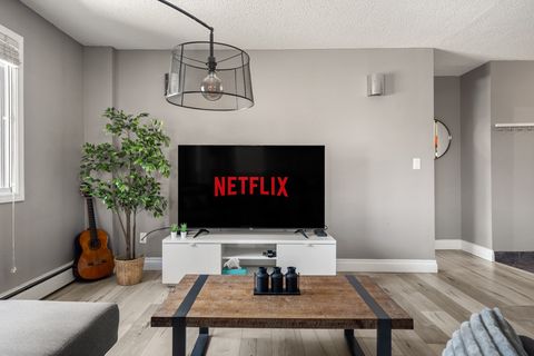 Our living room boasts a blend of modern comfort and technology, featuring a plush sofa for ultimate relaxation and a state-of-the-art Smart TV that promises endless entertainment at your fingertips.