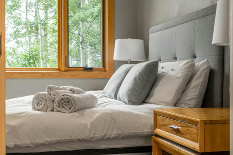 Bedroom one with queen sized bed and walk in closet.