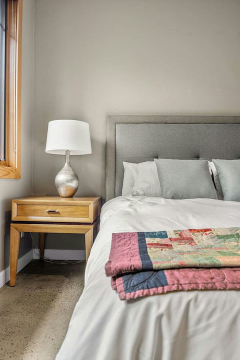 Bedroom one with queen sized bed and walk in closet.
