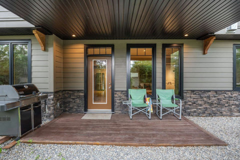 Separate entrance and deck looking north towards forest.
