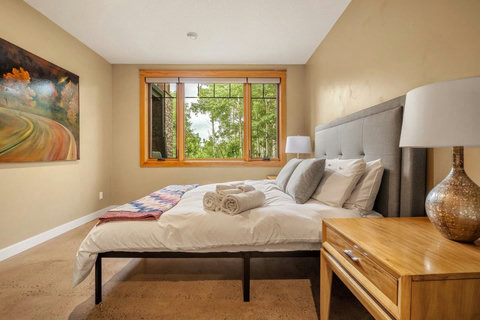 Bedroom one with queen sized bed and walk in closet.