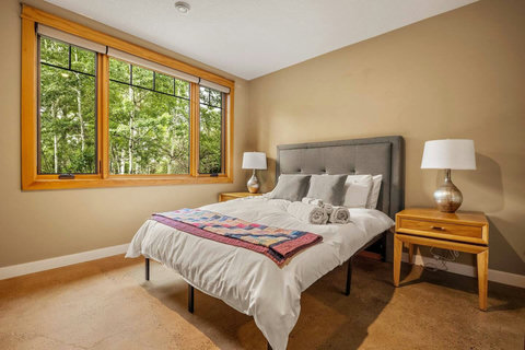 Bedroom one with queen sized bed and walk in closet.