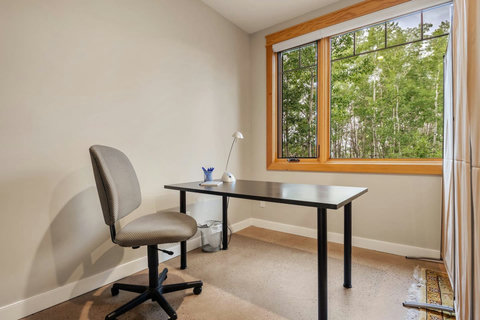 Dedicated work space with west-facing windows that have light reducing blinds.