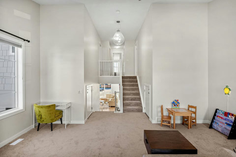 Expansive bonus room with dedicated office space, kids area and luxurious lounger couch.
