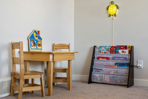Cute & cozy kids corner with plenty of books.