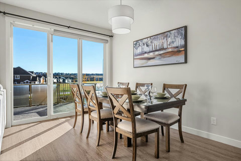 Dining area equipped with all dinner ware, including wine glasses.