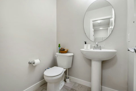 Generous half bathroom equipped with bidet toilet for added convenience