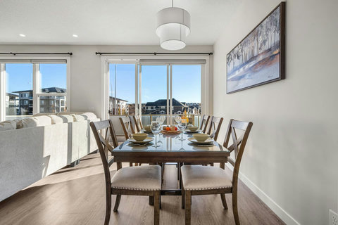 Dining area equipped with all dinner ware, including wine glasses.