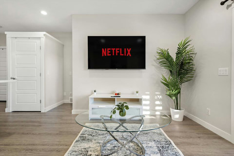 Cozy, luxurious & modern living room with abundant natural ligh, 65" Smart TV with Netflix to enjoy your favourite shows, movies  and more!