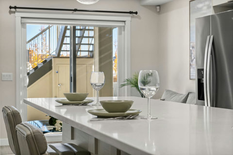 Dining area equipped with all dinner ware, including wine glasses.