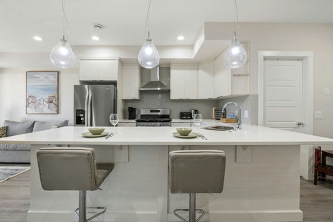Dining area equipped with all dinner ware, including wine glasses.