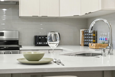 Dining area equipped with all dinner ware, including wine glasses.