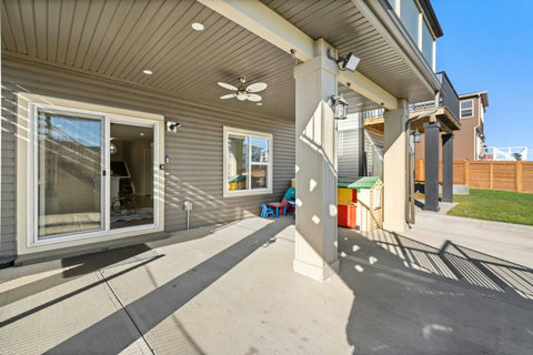 Private entrance, kids play area under covered patio with outdoor ceiling fan to enjoy outdoor activities.