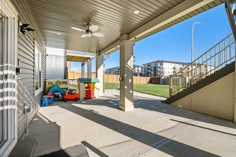Private entrance, kids play area under covered patio with outdoor ceiling fan to enjoy outdoor activities.