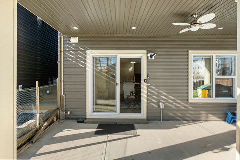 Private entrance and covered patio with outdoor ceiling fan to enjoy outdoor activities.