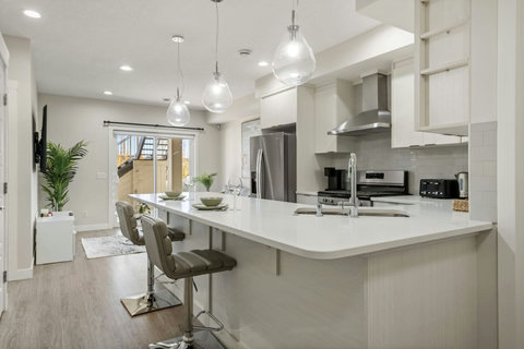 Dining area equipped with all dinner ware, including wine glasses.