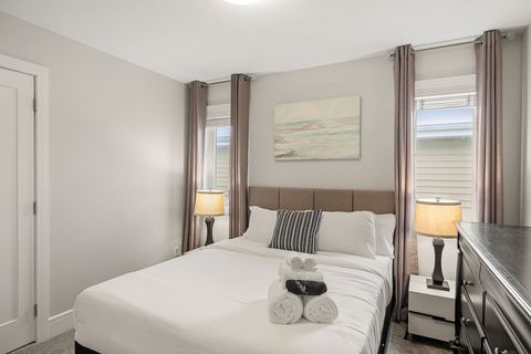 Drift off in comfort with our queen bed, outfitted with fresh, plush bedding and accented by modern dimmable night lamps.