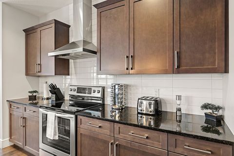 Fully-equipped kitchen, boasting a spice rack, ice maker, modern appliances, and a coffee machine for your morning brew.