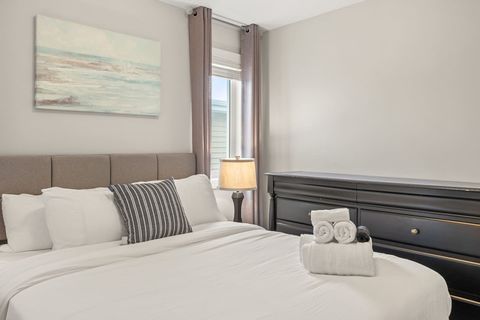 Drift off in comfort with our queen bed, outfitted with fresh, plush bedding and accented by modern dimmable night lamps.