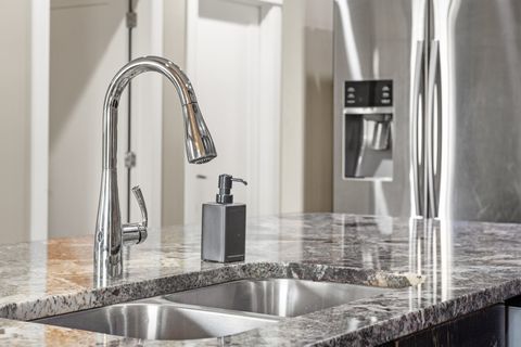 Fully-equipped kitchen, boasting a ice maker, modern appliances, and a coffee machine for your morning brew.