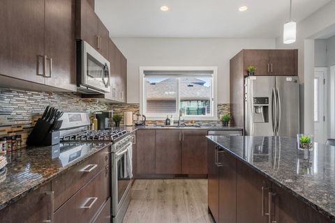Our Warm Brown Toned Kitchen Featuring A Cozy Island And Spacious Fridge