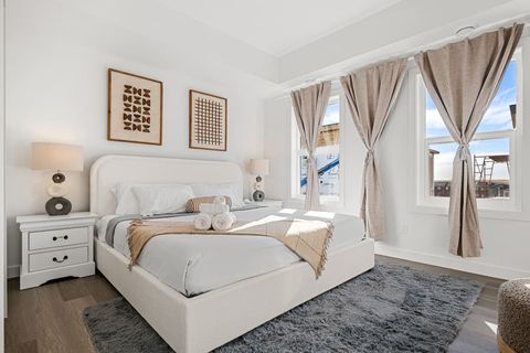 Indulge in a luxurious night’s sleep in Bedroom #1, featuring a king-size bed with ultra-soft, luxurious linens, blackout curtains for restful sleep, and a stylish mirror to complete the room’s modern look.