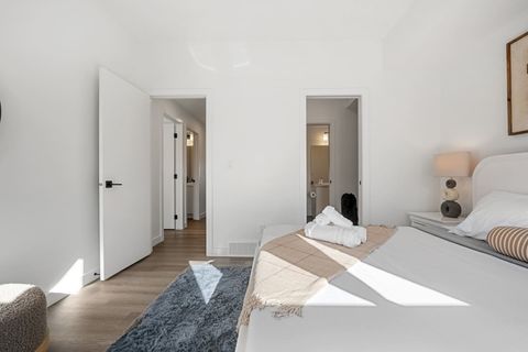 Indulge in a luxurious night’s sleep in Bedroom #1, featuring a king-size bed with ultra-soft, luxurious linens, blackout curtains for restful sleep, and a stylish mirror to complete the room’s modern look.