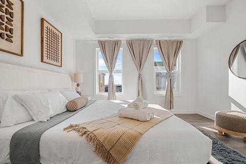 Indulge in a luxurious night’s sleep in Bedroom #1, featuring a king-size bed with ultra-soft, luxurious linens, blackout curtains for restful sleep, and a stylish mirror to complete the room’s modern look.