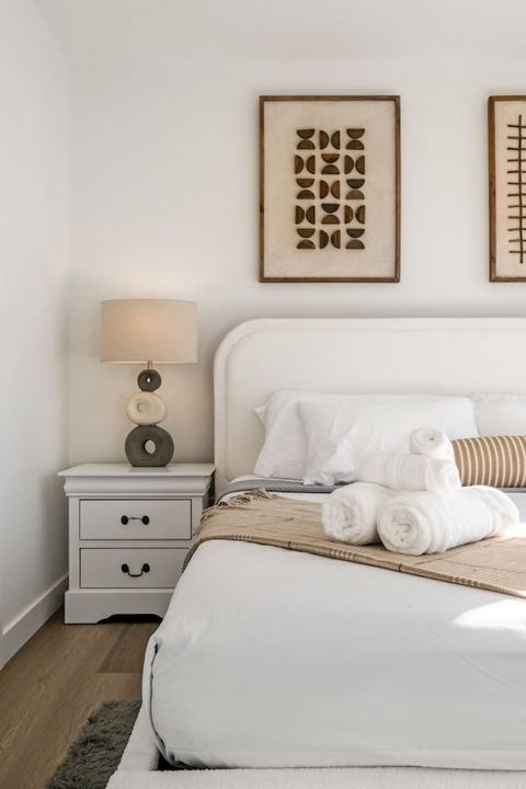 Indulge in a luxurious night’s sleep in Bedroom #1, featuring a king-size bed with ultra-soft, luxurious linens, blackout curtains for restful sleep, and a stylish mirror to complete the room’s modern look.