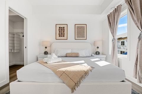 Indulge in a luxurious night’s sleep in Bedroom #1, featuring a king-size bed with ultra-soft, luxurious linens, blackout curtains for restful sleep, and a stylish mirror to complete the room’s modern look.