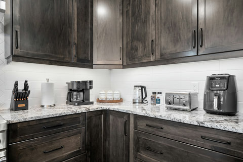 Fully equipped kitchen with modern appliances and granite countertops