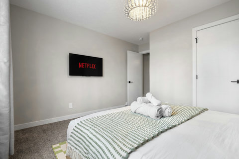 Comfortable guest bedroom featuring a smart TV for your favorite shows