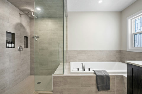 Spa-like master bath with freestanding soaking tub and glass-enclosed shower