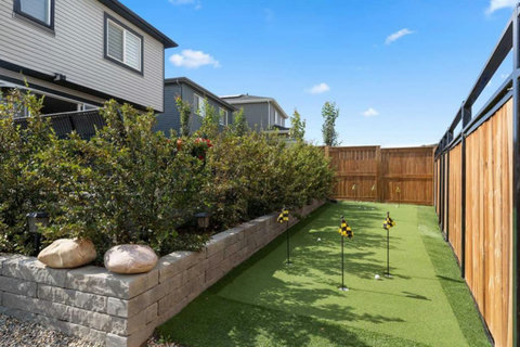 Private backyard oasis with putting green and modern landscaping