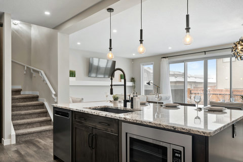 Sleek kitchen featuring a striking dark island and premium granite countertops