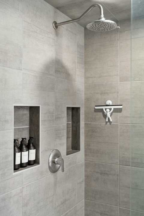 Luxurious rainfall shower with thoughtful built-in storage for toiletries